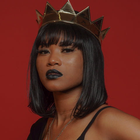 attractive black young woman wearing a gold mylar crown