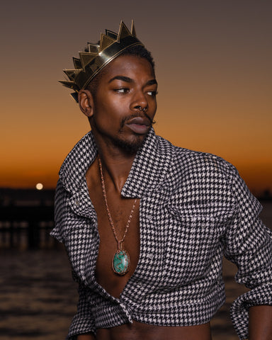 attractive black young man wearing a gold mylar crown