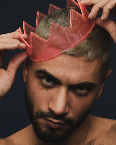 attractive white male model wearing clear pink crown